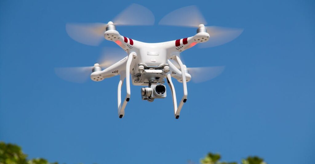 A white drone flying with camera against a clear blue sky in La Libertad.